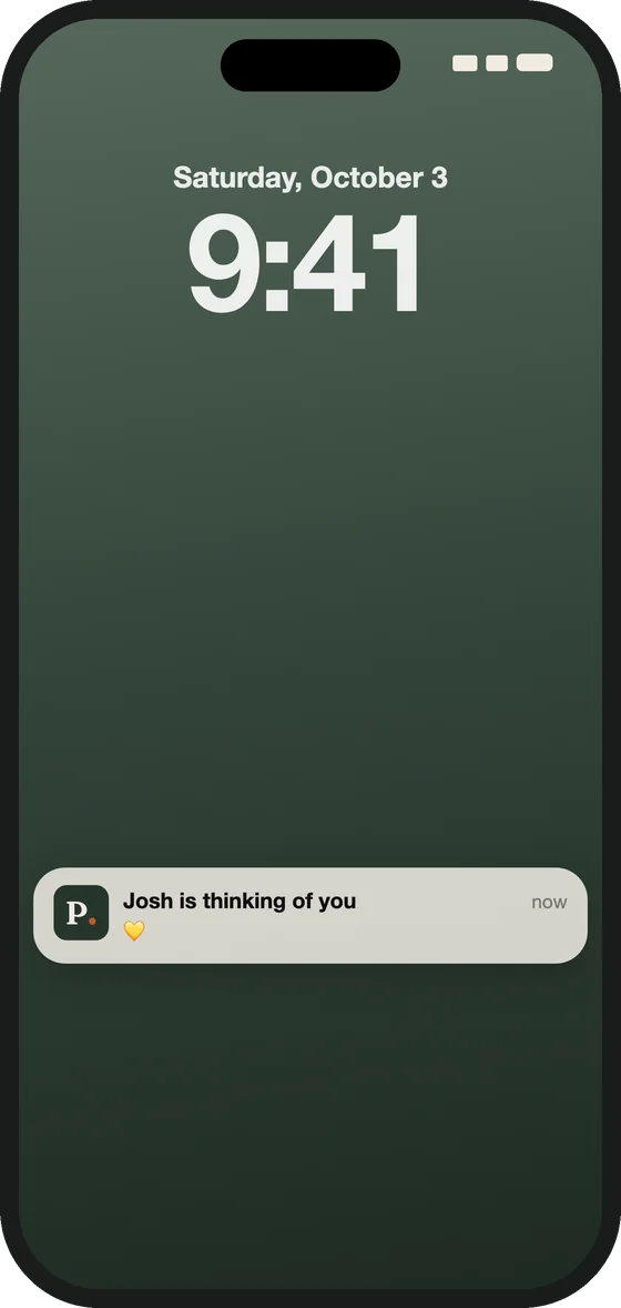 A phone's lock screen with a notification: a name, thinking of you, and a yellow heart